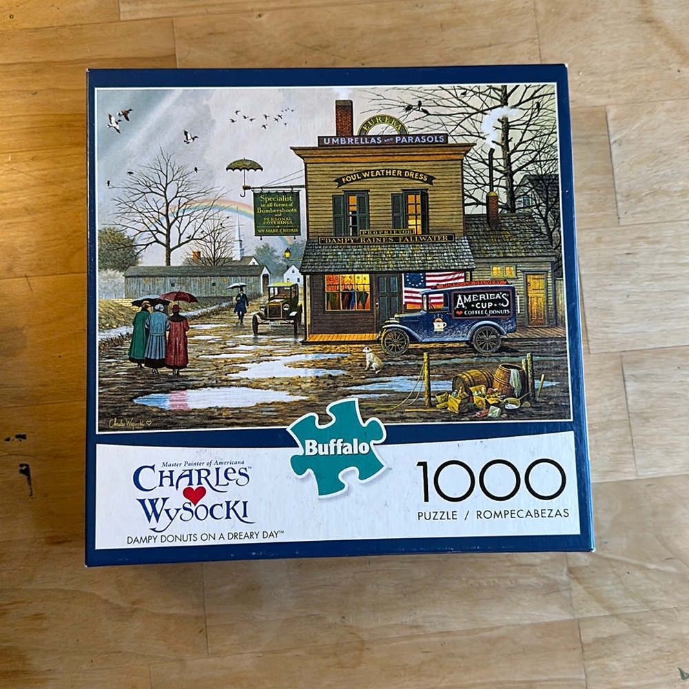 Charles Wysocki 1000 piece puzzle “Dampy Donuts on a Dreary Day”
